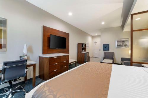 a bedroom with a bed and a tv and a desk at Best Western Plus Gardena-Los Angeles Inn & Suites in Gardena