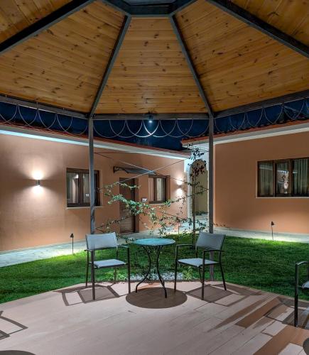 a patio with a table and chairs in a tent at 1929 Boutique Residences in Ioannina