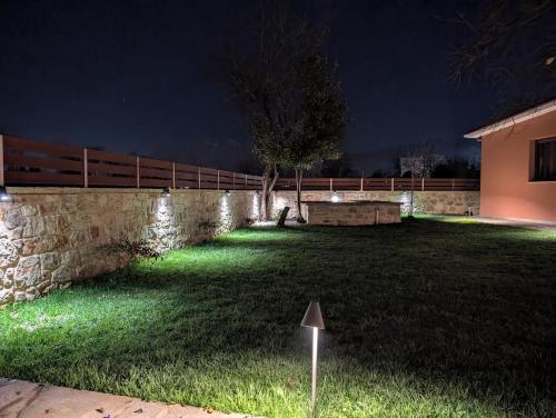 a yard at night with a fence and lights at 1929 Boutique Residences in Ioannina