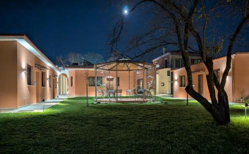 a building with a gazebo in a yard at night at 1929 Boutique Residences in Ioannina