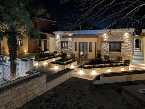 a house with a courtyard at night with lights at 1929 Boutique Residences in Ioannina