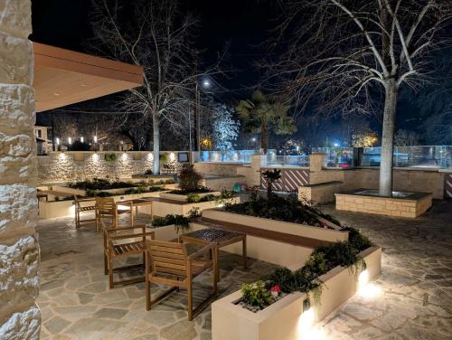 a patio with tables and chairs at night at 1929 Boutique Residences in Ioannina