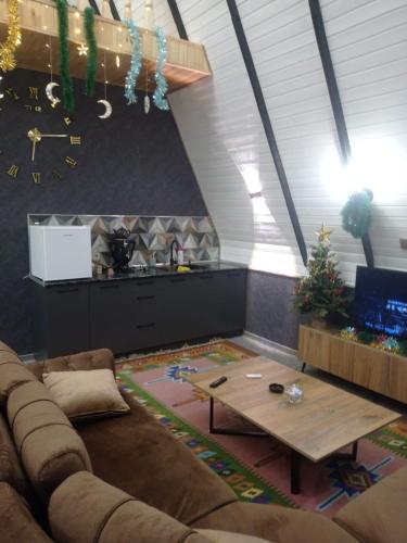 a living room with a couch and a table at 40 steps Aframe House in Uçgün
