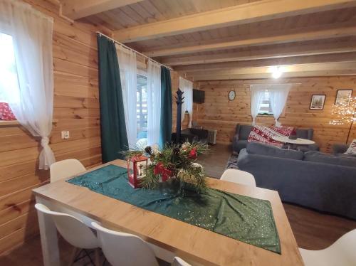 a living room with a table and a couch at Wiejska Sielanka noclegi Ustroń in Ustroń