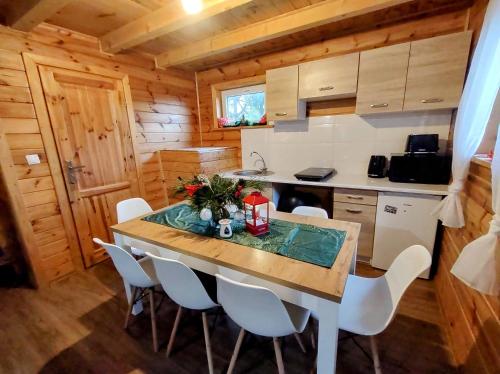 a kitchen with a table and chairs in a cabin at Wiejska Sielanka noclegi Ustroń in Ustroń