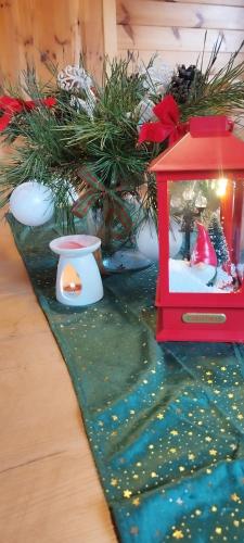 a red lantern sitting on top of a table at Wiejska Sielanka noclegi Ustroń in Ustroń