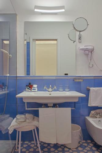a bathroom with a sink and a mirror at Hotel Aurora in Amalfi