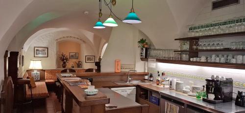 a large kitchen with a counter and a counter top at Hotel Schlair in Kremsmünster