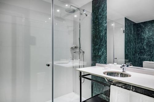 a bathroom with a sink and a shower at AC Hotel Avenida de América by Marriott in Madrid