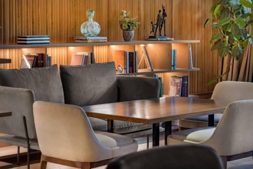 a conference room with a wooden table and chairs at AC Hotel Avenida de América by Marriott in Madrid