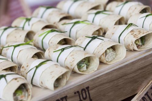 a bunch of burritos lined up on a table at AC Hotel Avenida de América by Marriott in Madrid