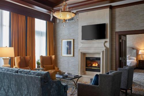 a living room with a couch and a fireplace at Renaissance Montgomery Hotel & Spa at the Convention Center in Montgomery