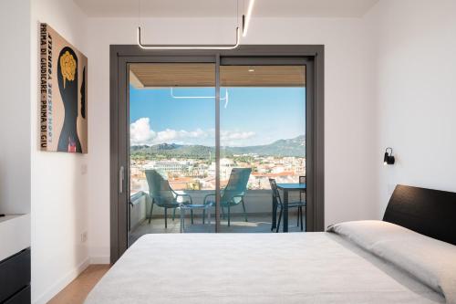 a bedroom with a view of a table and chairs at Alfiere Arc Loft by Klodge in Olbia