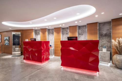 a lobby with a red exhibit in the middle at Renaissance Paris Republique Hotel & Spa in Paris
