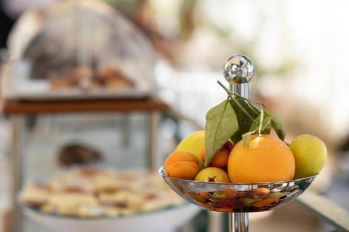 a bowl of oranges and other fruits on a table at Hotel Aurora in Amalfi