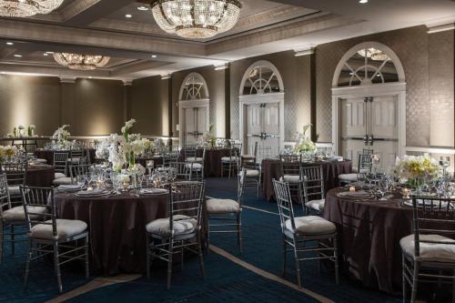 a set up for a wedding in a ballroom with tables and chairs at Renaissance Waterford Oklahoma City Hotel in Oklahoma City