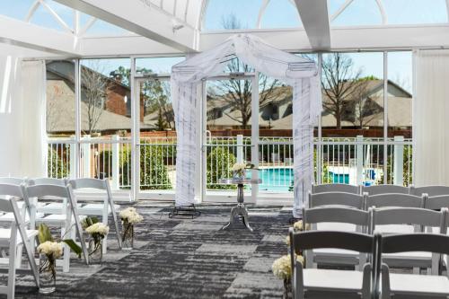 a wedding ceremony in a marquee with white chairs at Renaissance Waterford Oklahoma City Hotel in Oklahoma City