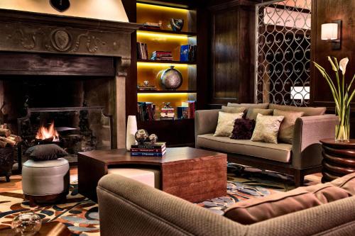 a living room with a couch and a fireplace at Renaissance Tuscany Il Ciocco Resort & Spa in Barga