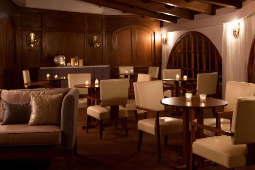a dining room with tables and chairs and candles at Renaissance Tuscany Il Ciocco Resort & Spa in Barga