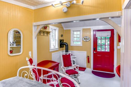 a room with a red door and a red chair at Studio with Trail Access about 10 Mi to Brattleboro! in Bernardston