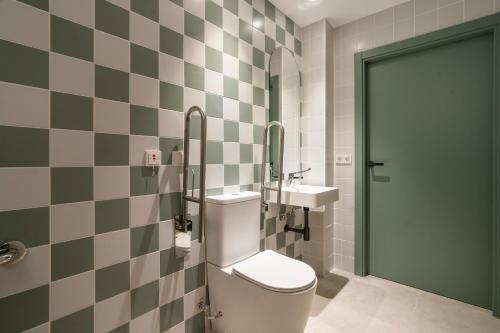 a bathroom with a toilet and a sink at VLC HOST - Reina 168 in Valencia