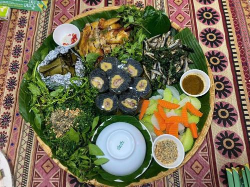 a plate of food with vegetables on a table at Bac Son Homestay in Bắc Sơn