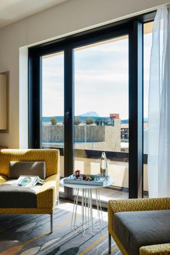 a living room with a couch and a table at Renaissance Aix-en-Provence Hotel in Aix-en-Provence