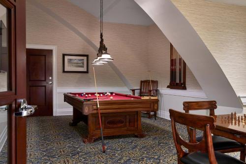a games room with a pool table and an archway at The Battle House Renaissance Mobile Hotel & Spa in Mobile