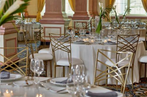 a dining room with a table with glasses on it at The Battle House Renaissance Mobile Hotel & Spa in Mobile