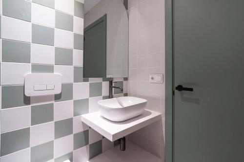 a bathroom with a sink and a mirror at VLC HOST - Reina 168 in Valencia