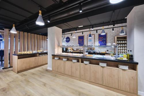 a bakery with wooden counters and aasteryasteryasteryasteryasteryasteryasteryasteryastery at Holiday Inn Express Lublin by IHG in Lublin