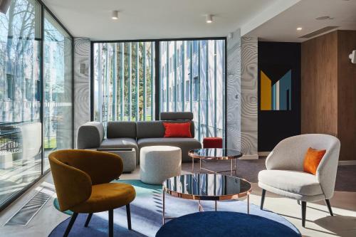 a living room with a couch and chairs at Holiday Inn Express Lublin by IHG in Lublin