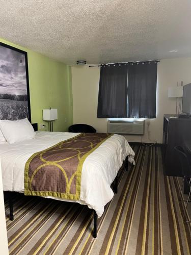 a hotel room with a bed and a window at Super 8 by Wyndham Nebraska City in Percival