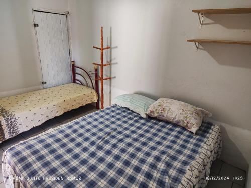 Ένα ή περισσότερα κρεβάτια σε δωμάτιο στο Residencial Ramos varanda