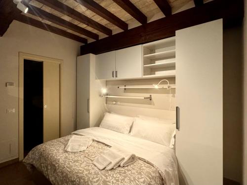a bedroom with a bed with two towels on it at Niki O. Apartments in Parma