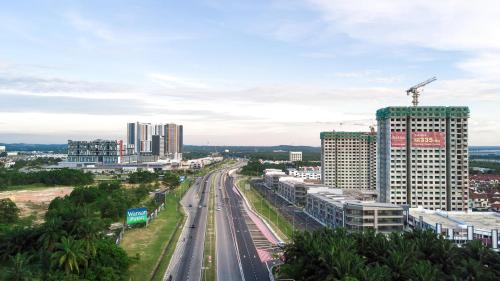 a city with tall buildings and a highway at The Red Room Alanis Residence in Sepang