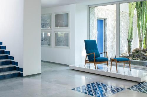 a living room with two chairs and a staircase at Parco dei Principi in Sorrento