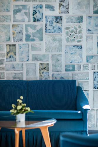 a blue couch in a room with a table at Parco dei Principi in Sorrento