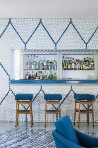 a bar with two blue stools in a room at Parco dei Principi in Sorrento