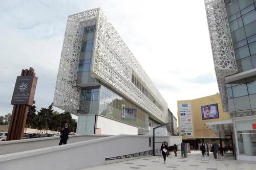 a large building with people walking in front of it at Apartment with parking in Rabat Central Location in Rabat