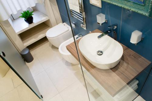 a bathroom with a sink and a toilet at Amnis rooms in Salerno