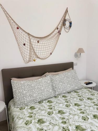 a bedroom with a hammock hanging above a bed at Villa Chimera in Pachino