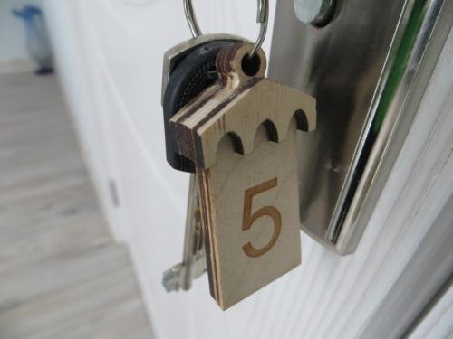 a lock on a door with the number five at Guesthouse Bacha & Lia in Mestia