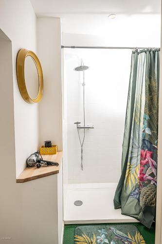 a bathroom with a shower with a shower curtain at C'est Chouette le gîte ! in Saint-Jodard