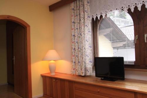 a television sitting on a dresser next to a window at Appartements Reiterhaus in Wagrain
