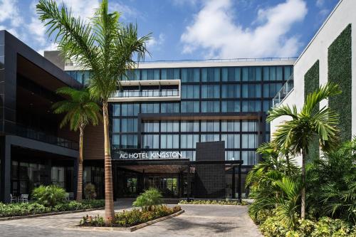 an office building with palm trees in front of it at AC Hotel by Marriott Kingston, Jamaica in Kingston
