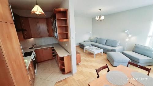 a small apartment with a kitchen and a living room at Apartament Metro Natolin in Warsaw
