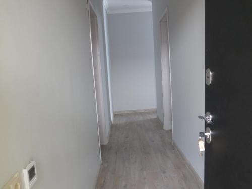 an empty hallway with a door and a wooden floor at Guesthouse Bacha & Lia in Mestia