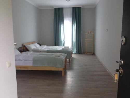 a bedroom with two beds and a window at Guesthouse Bacha & Lia in Mestia