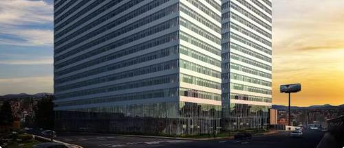 a tall office building with a lot of windows at Apartamento Nuevo y Lujoso! in Mexico City